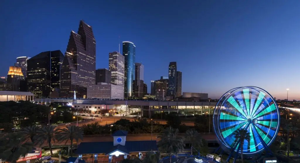 Houston skyline with ferris wheel at dusk.