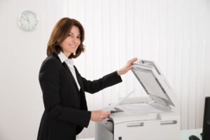 employee making copy for her meeting copying