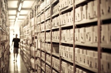 scanning hallway of shelves with boxes of documents