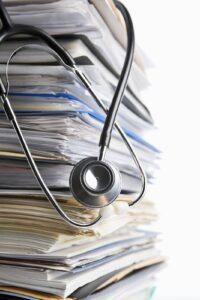 scanning a stack of medical records with stethoscope